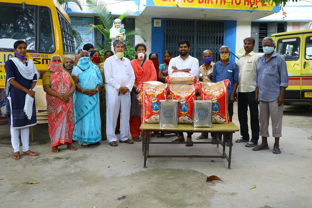 Khaja Moinuddin and a group gathered beside food supplies