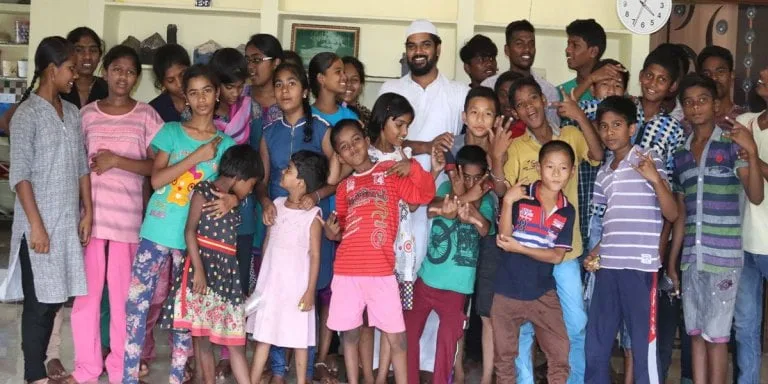 Khaja Moinuddin with a group of children and young people